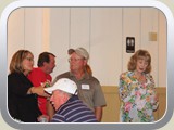 Barb Gruner, Buzzy Jones, Sandy Peterson with Tim Cook in the background